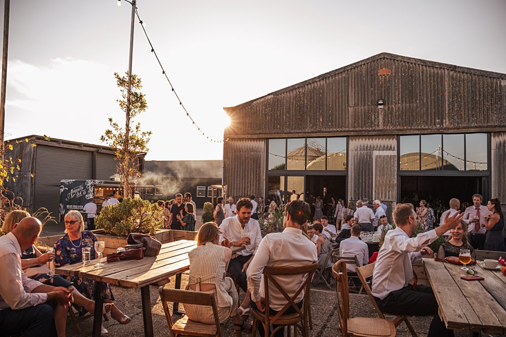 Multi coloured Summer wedding with a bride wearing green at The Barns at Lodge Farm. Essex documentary wedding photographer