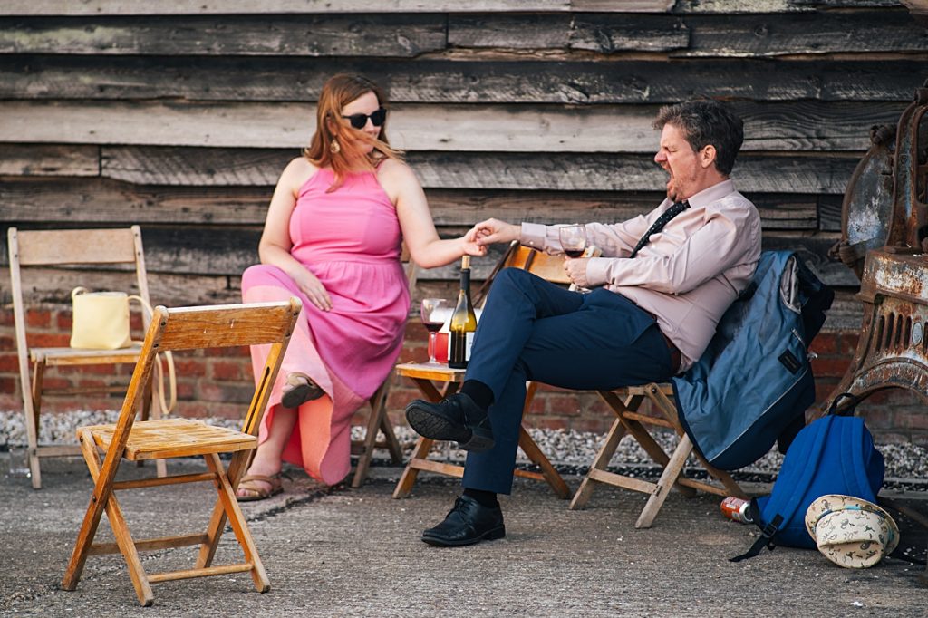 Multi coloured Summer wedding with a bride wearing green at The Barns at Lodge Farm. Essex documentary wedding photographer
