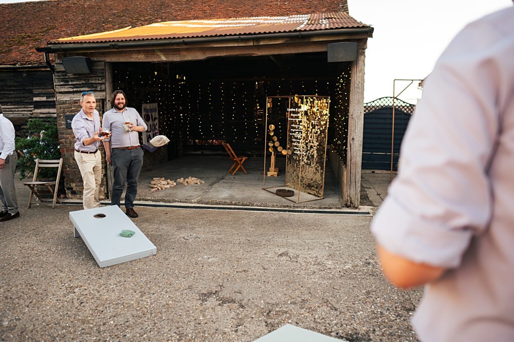 Multi coloured Summer wedding with a bride wearing green at The Barns at Lodge Farm. Essex documentary wedding photographer