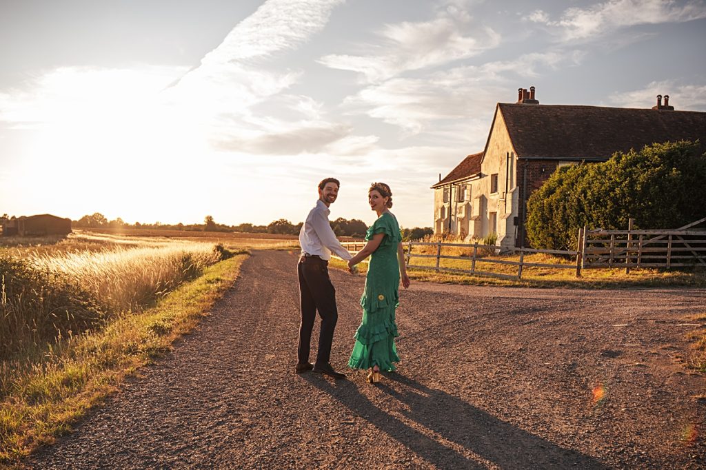 Multi coloured Summer wedding with a bride wearing green at The Barns at Lodge Farm. Essex documentary wedding photographer