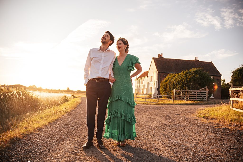 Multi coloured Summer wedding with a bride wearing green at The Barns at Lodge Farm. Essex documentary wedding photographer