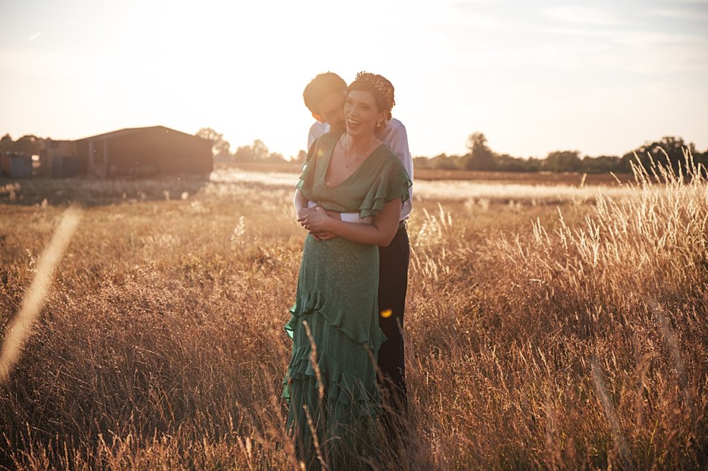 Multi coloured Summer wedding with a bride wearing green at The Barns at Lodge Farm. Essex documentary wedding photographer