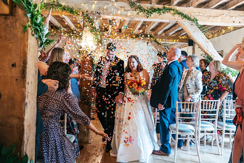 Confetti thrown on bride and groom at Granary Estates Woodditton