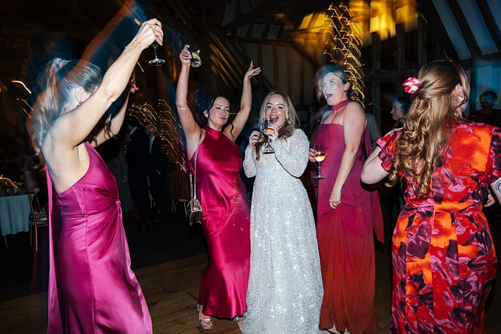 hot pink, orange and disco balls for autumn wedding at Blake Hall